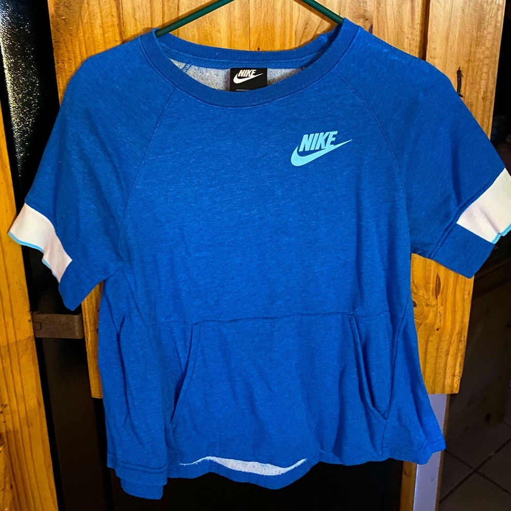 The brand is Nike. The material is like a sweatshirt. Shortsleeved.  Adult XS